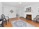 Hardwood floors complement the living room with fireplace, light walls, and classic details at 701 E Nash St, Spring Hope, NC 27882