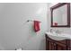 Neat half bath featuring a vanity with a sink, a mirror, and a towel rack at 704 Benchmark Dr, Raleigh, NC 27615