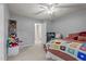 Cozy bedroom with plush carpeting, ceiling fan and doorway to hallway at 704 Benchmark Dr, Raleigh, NC 27615