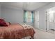 Comfortable bedroom features plush carpeting and lots of natural light at 704 Benchmark Dr, Raleigh, NC 27615
