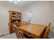 Traditional dining room with wooden table, chairs, and hutch, adjacent to the kitchen at 704 Benchmark Dr, Raleigh, NC 27615