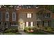 Charming townhome featuring lush landscaping, purple shutters, and inviting entryway at 704 Benchmark Dr, Raleigh, NC 27615