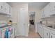 White kitchen with appliances and a seamless transition to the connected dining room at 704 Benchmark Dr, Raleigh, NC 27615
