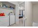 Laundry room featuring washer, dryer and shelving with access to upstairs bedroom at 704 Benchmark Dr, Raleigh, NC 27615