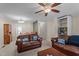 Spacious living room with plush sofas, ceiling fan, and open access to the dining area at 704 Benchmark Dr, Raleigh, NC 27615
