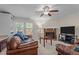 Comfortable living space with a brick fireplace, built-in shelving, and access to a deck at 704 Benchmark Dr, Raleigh, NC 27615