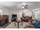 Inviting living room featuring a brick fireplace, ceiling fan, and comfortable seating area at 704 Benchmark Dr, Raleigh, NC 27615