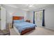 Comfortable bedroom with a king-size bed, ceiling fan, and a window with curtains at 704 Benchmark Dr, Raleigh, NC 27615