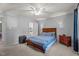 Spacious main bedroom with a king-size bed, ceiling fan, and ensuite bathroom at 704 Benchmark Dr, Raleigh, NC 27615