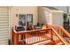 Outdoor patio featuring a grill, dining set, and wooden railing at 704 Benchmark Dr, Raleigh, NC 27615