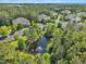 Aerial view of pond, homes, and lush green trees in a community at 711 Providence Glen Dr, Chapel Hill, NC 27514