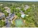 Aerial view of community tennis courts, pool, playground, and parking with trees at 711 Providence Glen Dr, Chapel Hill, NC 27514