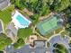Overhead view featuring community pool, tennis courts, playground, and green spaces at 711 Providence Glen Dr, Chapel Hill, NC 27514
