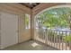 Balcony with view of green lawn and trees with parking area beyond a white picket fence at 711 Providence Glen Dr, Chapel Hill, NC 27514