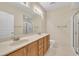 Bright bathroom with double sinks, wooden cabinets, and a glass-enclosed shower at 711 Providence Glen Dr, Chapel Hill, NC 27514