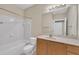 Bathroom featuring a sink with wood cabinets, a mirror and a bathtub with shower at 711 Providence Glen Dr, Chapel Hill, NC 27514