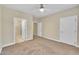 Bedroom featuring neutral carpet and paint, three doorways and bright lighting at 711 Providence Glen Dr, Chapel Hill, NC 27514