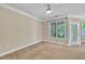 Spacious bedroom with a ceiling fan, neutral carpet, and access to outdoor space at 711 Providence Glen Dr, Chapel Hill, NC 27514