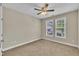 Bright bedroom with neutral carpet, paint and two windows overlooking greenery at 711 Providence Glen Dr, Chapel Hill, NC 27514