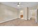 Spacious bedroom showcasing neutral carpet and paint, with two open doorways at 711 Providence Glen Dr, Chapel Hill, NC 27514