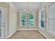 Bright dining room with ample natural light and a decorative chandelier above at 711 Providence Glen Dr, Chapel Hill, NC 27514