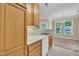 Kitchen with wooden cabinets and white appliances, opens into an adjoining dining area with ample natural light at 711 Providence Glen Dr, Chapel Hill, NC 27514