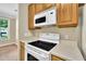 Close-up of stove and microwave highlighting the kitchen's functionality and the ample countertop space for meal preparation at 711 Providence Glen Dr, Chapel Hill, NC 27514