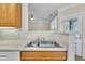 The stainless steel sink and faucet enhance the kitchen's design, connecting to a dining area with views through an indoor window at 711 Providence Glen Dr, Chapel Hill, NC 27514
