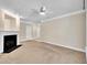 Open living area with fireplace, neutral carpet, and access to other rooms at 711 Providence Glen Dr, Chapel Hill, NC 27514