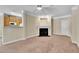 Living area featuring fireplace, ceiling fan, neutral paint, and access to kitchen at 711 Providence Glen Dr, Chapel Hill, NC 27514
