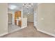 Open layout view featuring a kitchen area flowing into a carpeted space, enhanced by overhead lighting and neutral wall colors at 711 Providence Glen Dr, Chapel Hill, NC 27514