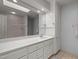Bright bathroom featuring a large mirror, vanity, and a shower with tile surround at 74002 Harvey, Chapel Hill, NC 27517