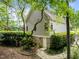 Back exterior view of house with side entrance door, beautiful landscaping, and stone pathway at 74002 Harvey, Chapel Hill, NC 27517