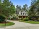 Lovely two-story home has a circular driveway, mature trees and manicured landscaping at 74002 Harvey, Chapel Hill, NC 27517