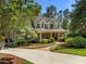 Lovely two-story home has a circular driveway, mature trees and manicured landscaping at 74002 Harvey, Chapel Hill, NC 27517