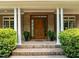 Inviting front entrance with a solid wood door and manicured greenery at 74002 Harvey, Chapel Hill, NC 27517