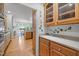 Well-lit kitchen area featuring wooden cabinets, countertop space, and hardwood flooring at 74002 Harvey, Chapel Hill, NC 27517
