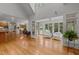 Open-concept living room showcasing hardwood floors, a sunroom, and a breakfast bar at 74002 Harvey, Chapel Hill, NC 27517