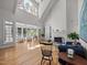 Spacious living room with high ceilings, fireplace, hardwood floors, and large windows for ample natural light at 74002 Harvey, Chapel Hill, NC 27517