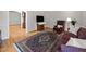 Comfortable living room with a leather chair, patterned rug, and hardwood floors at 74002 Harvey, Chapel Hill, NC 27517