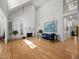 Open-concept living room featuring hardwood floors, a fireplace, built-in bookshelves, and plenty of natural light at 74002 Harvey, Chapel Hill, NC 27517