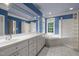 Beautiful primary bath with dual vanities, a soaking tub, and a glass block shower at 74002 Harvey, Chapel Hill, NC 27517