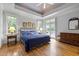 Inviting main bedroom with hardwood floors, tray ceilings, and backyard access at 74002 Harvey, Chapel Hill, NC 27517
