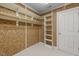 Walk-in closet featuring built-in shelving, hanging rods, and neutral carpeting at 74002 Harvey, Chapel Hill, NC 27517