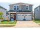 Charming two-story home featuring a spacious two-car garage, a red front door, and a well-manicured lawn at 809 Ottawa Dr, Garner, NC 27529