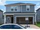 Two-story home featuring a two-car garage, horizontal siding, and a front yard at 809 Ottawa Dr, Garner, NC 27529