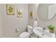 Stylish half-bathroom featuring decorative art and a modern vessel sink at 8113 Huskfield Ct, Apex, NC 27539