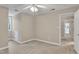 Carpeted bedroom features neutral paint, a ceiling fan, a window and access to the rest of the home at 8113 Huskfield Ct, Apex, NC 27539