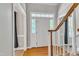 Welcoming foyer with hardwood floors, a staircase, and plenty of natural light at 8113 Huskfield Ct, Apex, NC 27539
