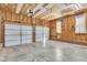 Spacious two car garage with white doors ready for vehicles and storage in your new home at 8113 Huskfield Ct, Apex, NC 27539